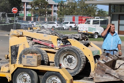 Utility vehicles squashed at building disaster site
