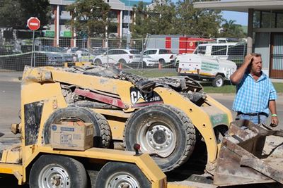 Utility vehicles squashed at building disaster site