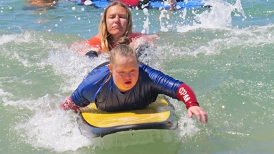 Special needs children enjoy beach, surfing