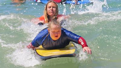 Special needs children enjoy beach, surfing