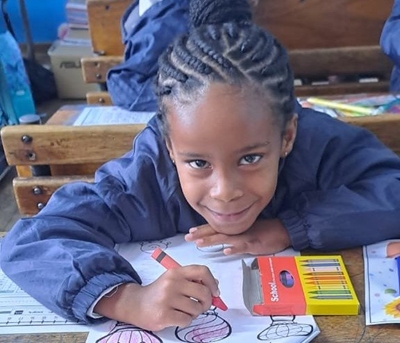 Colouring in, singing on their first day at school