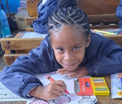 Colouring in, singing on their first day at school