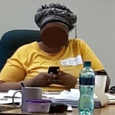 Official on cellphone while client waits