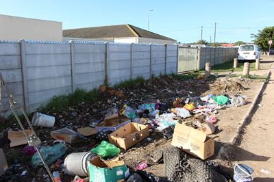 Illegal dumping and missing pavement outside Mossel Bay FCS