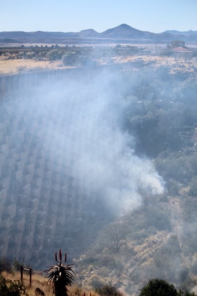 Fire burns at dam wall