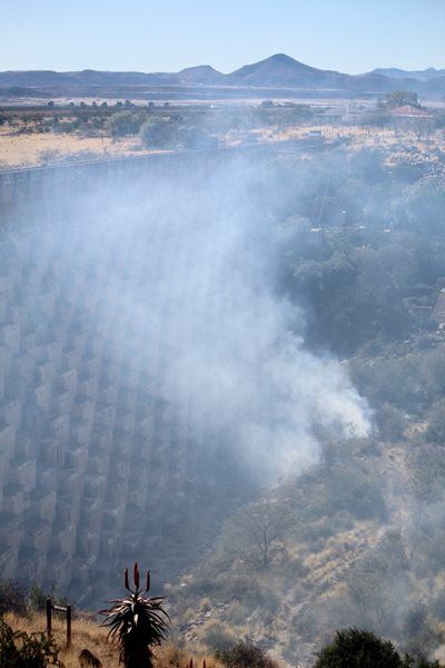 Fire burns at dam wall