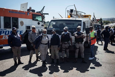 Chaos, the order of the day as angry residents ‘gun’ for police minister Cele