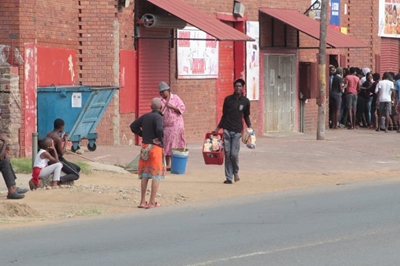 Scenes of chaos as protesters loot local shops