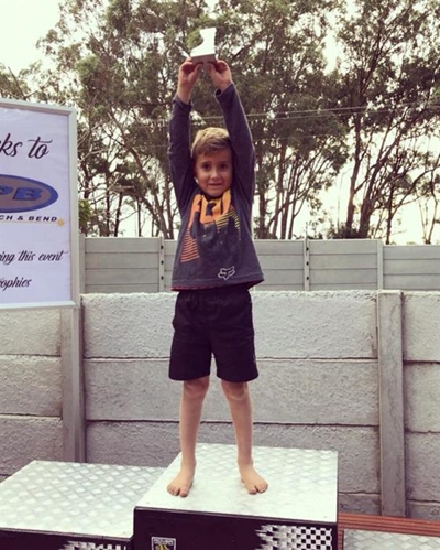 Young motocross rider on a winning track
