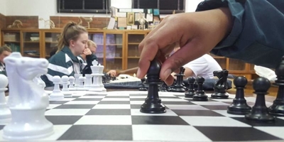 100 players to take on chess champ