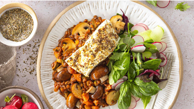 Roasted hake served on a bed of tomato and mushroom lentils 