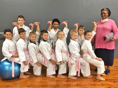 Karateka wear pink belts for cancer