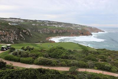 Golfers work hard to card down podium scores in wind