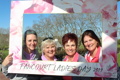Lady golfers celebrate with pink champagne
