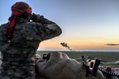 Convoy plucks women, children from last IS holdout in Syria