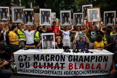 Anti-G7 activists march with 'stolen' Macron portraits 