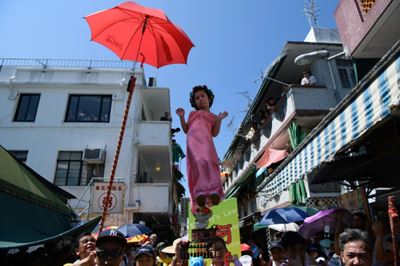 Hovering kids go political in Hong Kong festival parade