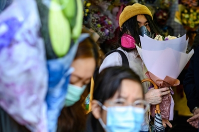 Virus-hit Hong Kong says it with face masks, not flowers 