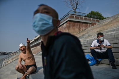 China raises Wuhan death toll as US plots re-opening