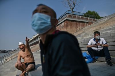 China raises Wuhan death toll as US plots re-opening