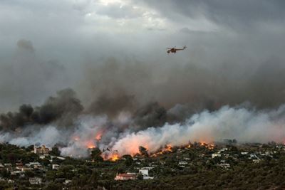Fire at their backs, Greek elderly flee with grandchildren