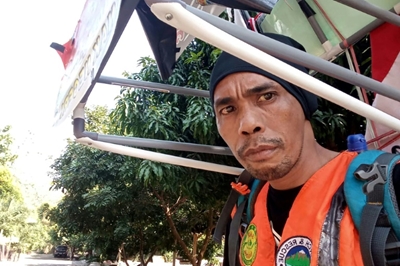Indonesian man walking in reverse to save forests 