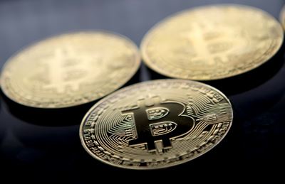 Bitcoin's true believers vow to ride out currency rollercoaster