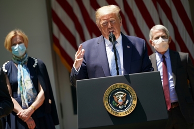 As virus surges, Trump under pressure to adopt mask