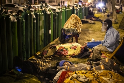 In Peru, people line up day and night for life-saving oxygen