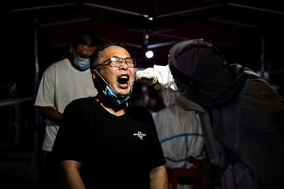 China restricts overseas travel to curb Covid outbreak
