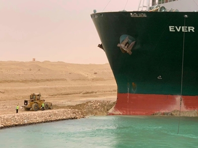 Egypt battles to refloat ship blocking Suez Canal as queues build