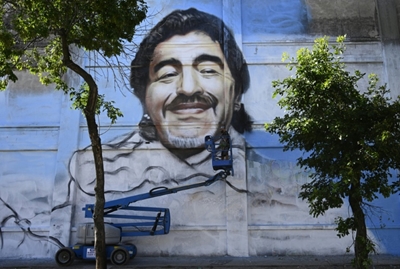 Street artist unveils mural to 'Saint' Diego Maradona