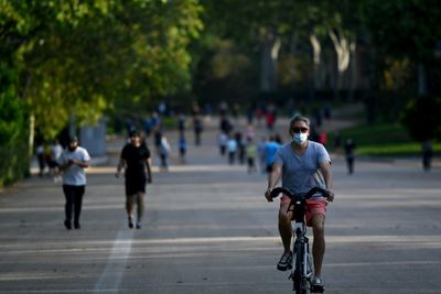 Parks packed, terraces open as Madrid and Barcelona celebrate easing