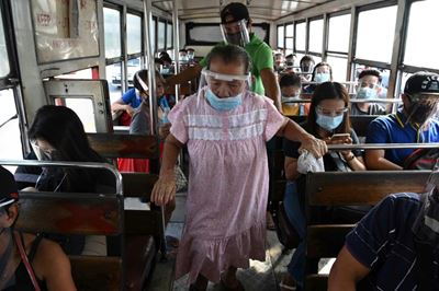 Strict mask, visor rules make Philippine commuters sweat