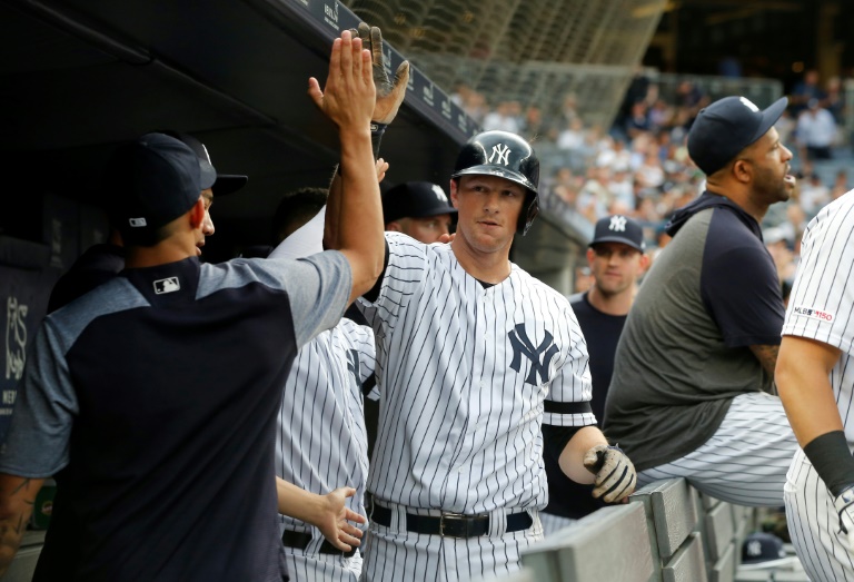 New York Yankees' DJ LeMahieu, left, celebrates with teammates