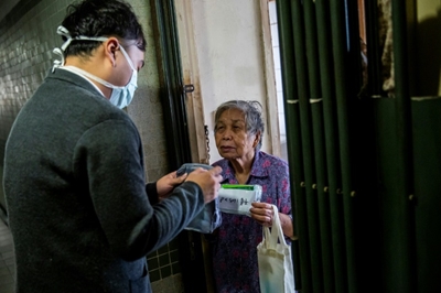 Hong Kong political rivals woo voters with free face masks