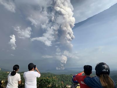 Ash pours from Philippine volcano, halting flights