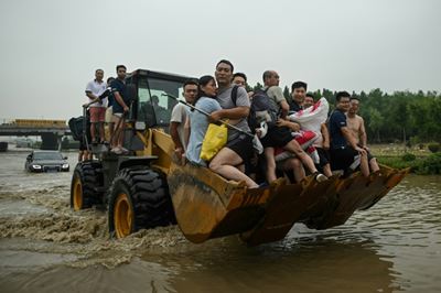 Villagers flee fresh floods in central China as typhoon approaches