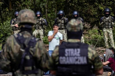 Migrants massing at border with Belarus help, Poland says