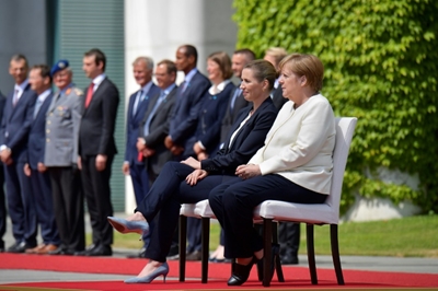 Merkel sits through anthems after shaking spells