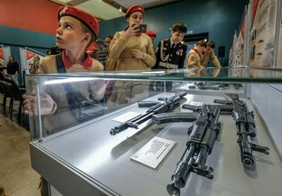 Russian cadets pose for selfies at Kalashnikov exhibition