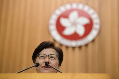 Hong Kong leader insists she will stay on