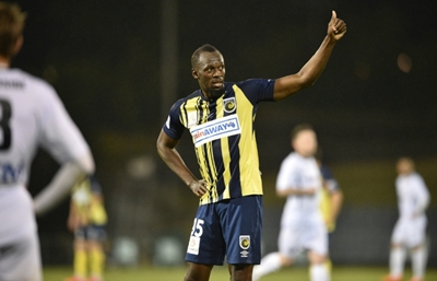 Bolt hanging up boots on football dream