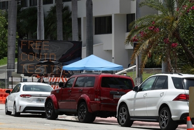 Florida reports 15,000 new virus cases in a day, a US record