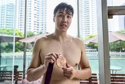 Chinese swimmer goes from Olympic podium to river police