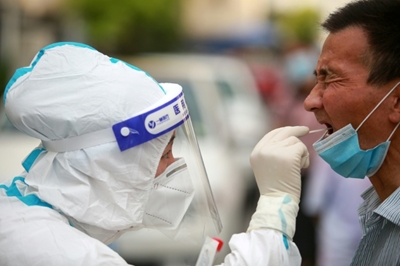 WHO calls for moratorium on booster shots as China curbs travel 