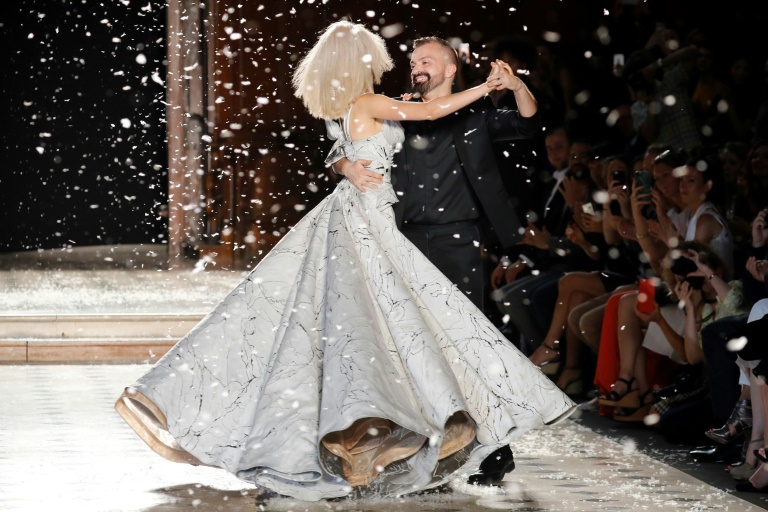 A model shows a wedding gown for French fashion designer Christian