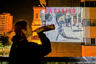 With streets silent, Latin American activists use walls to speak out