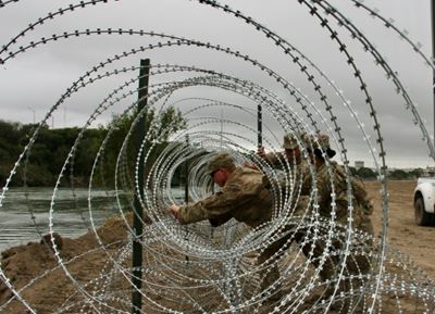US Army unfurls miles of fencing along border with Mexico