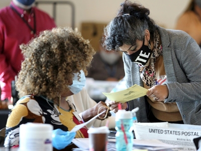 Gloved and masked, US vote counters keep focused on historic task